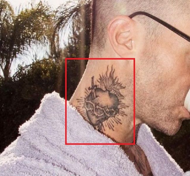 adam levine-dagger piercing heart tattoo