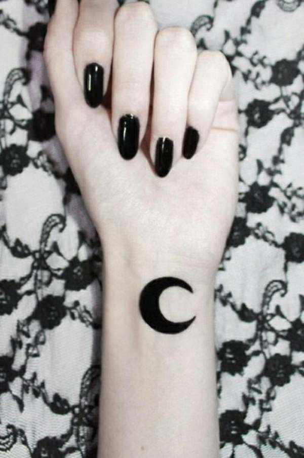 Minimalist moon tattoo on the left inner wrist