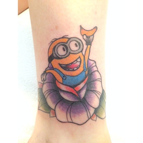 37 Super Cute Minion Tattoo Designs and Ideas 9. Minion On Flower Tattoo De...