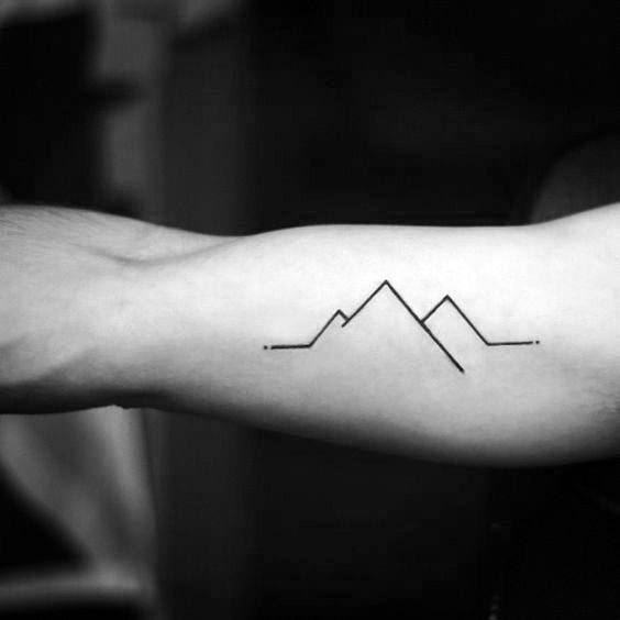 black and grey mountain scene inside arm tattoo by Cody Cook TattooNOW