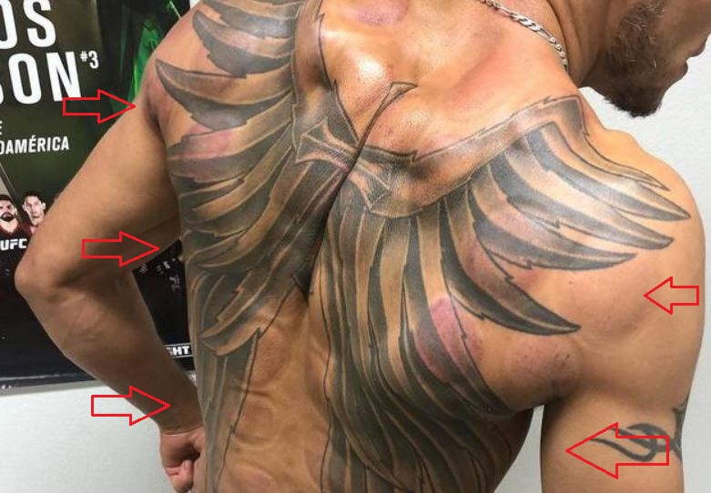 Tony Ferguson cross wings tattoo