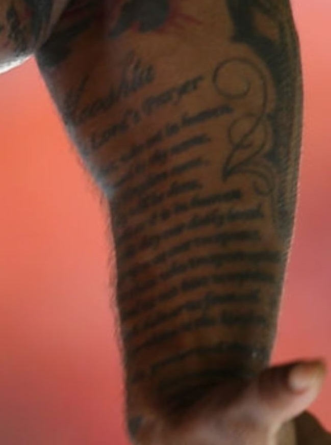 West writing on arm tattoo