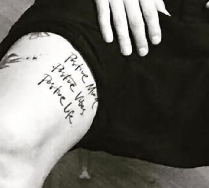 Alessandro thigh writing tattoo