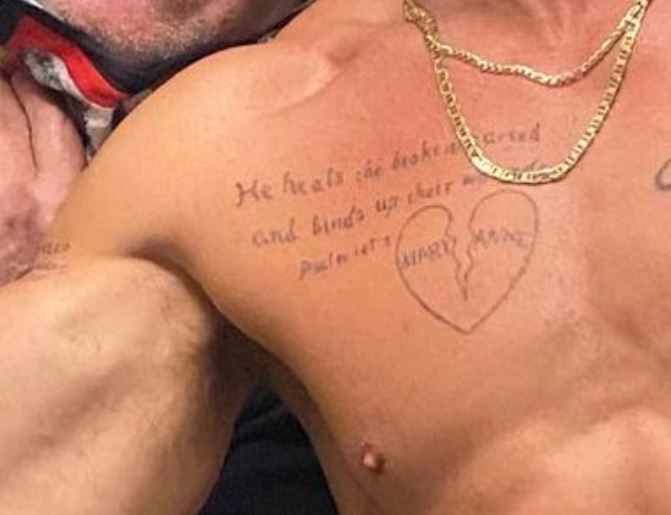 Jon writing on chest tattoo