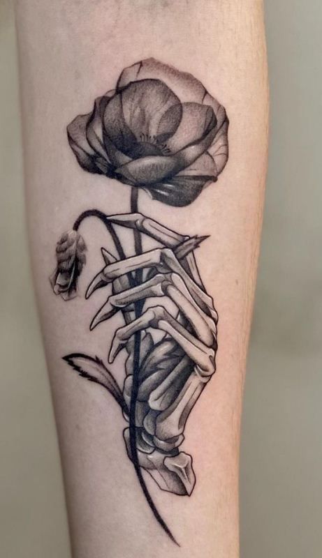 Poppy With Spooky Skeletal Grip Tattoo Design On Forearm