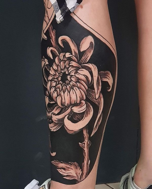 Awe-Inspiring Chrysanthemum Tattoo Design On Leg