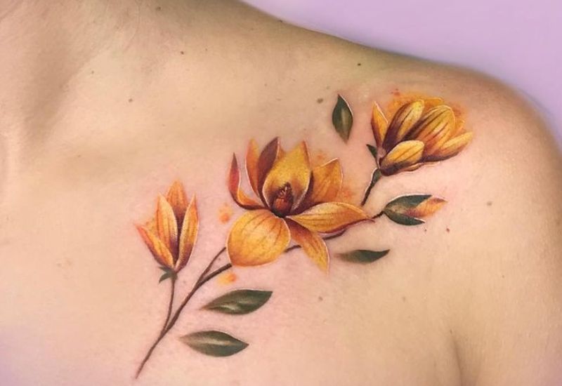 Gold Magnolia Tattoo Design near Collarbone