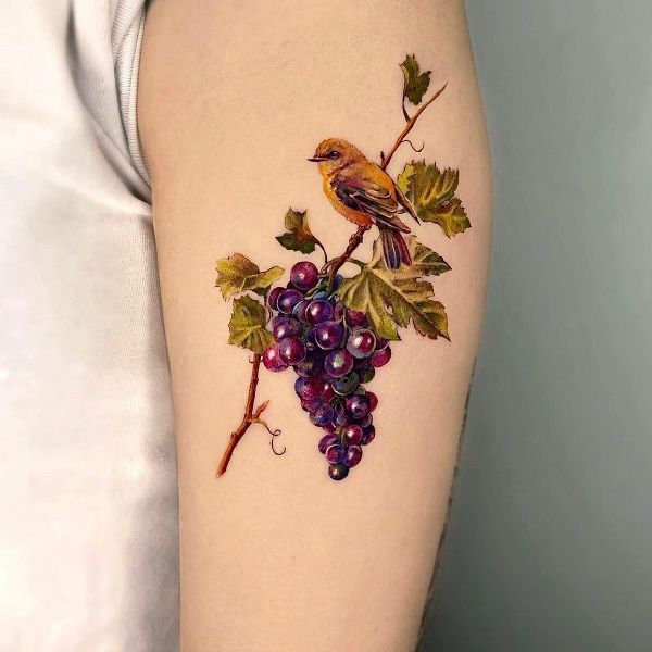 Grapes with a Bird Tattoo Design on Upper Arm
