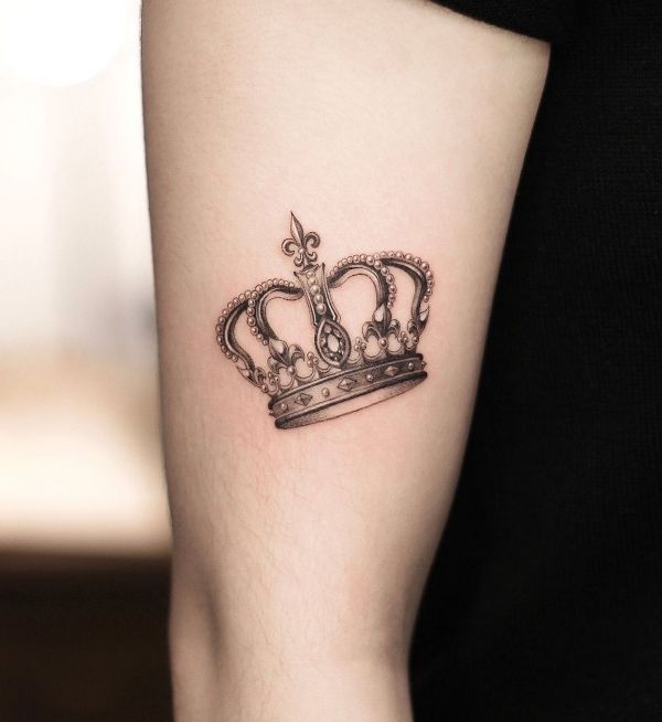 Elegant Crown Tattoo Design on Upper Arm