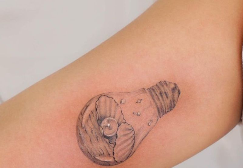 Pearl in Bulb Tattoo Design on Upper Arm 