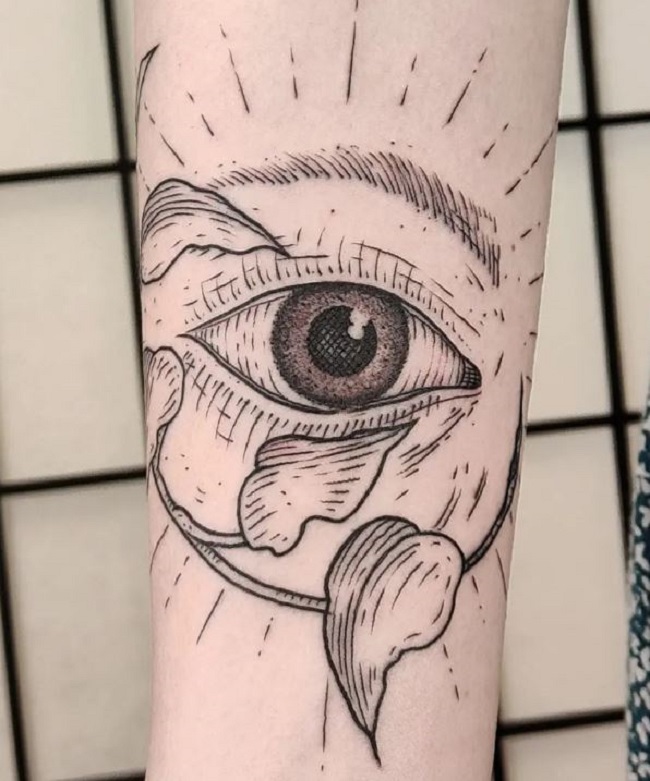 An Eye Tattoo With The Leaves On The Forearm