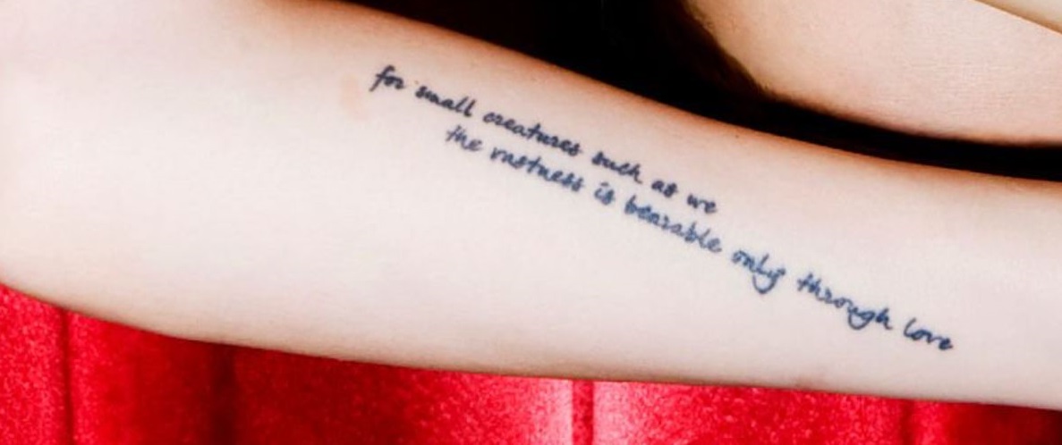 Rumer writing on arm tattoo